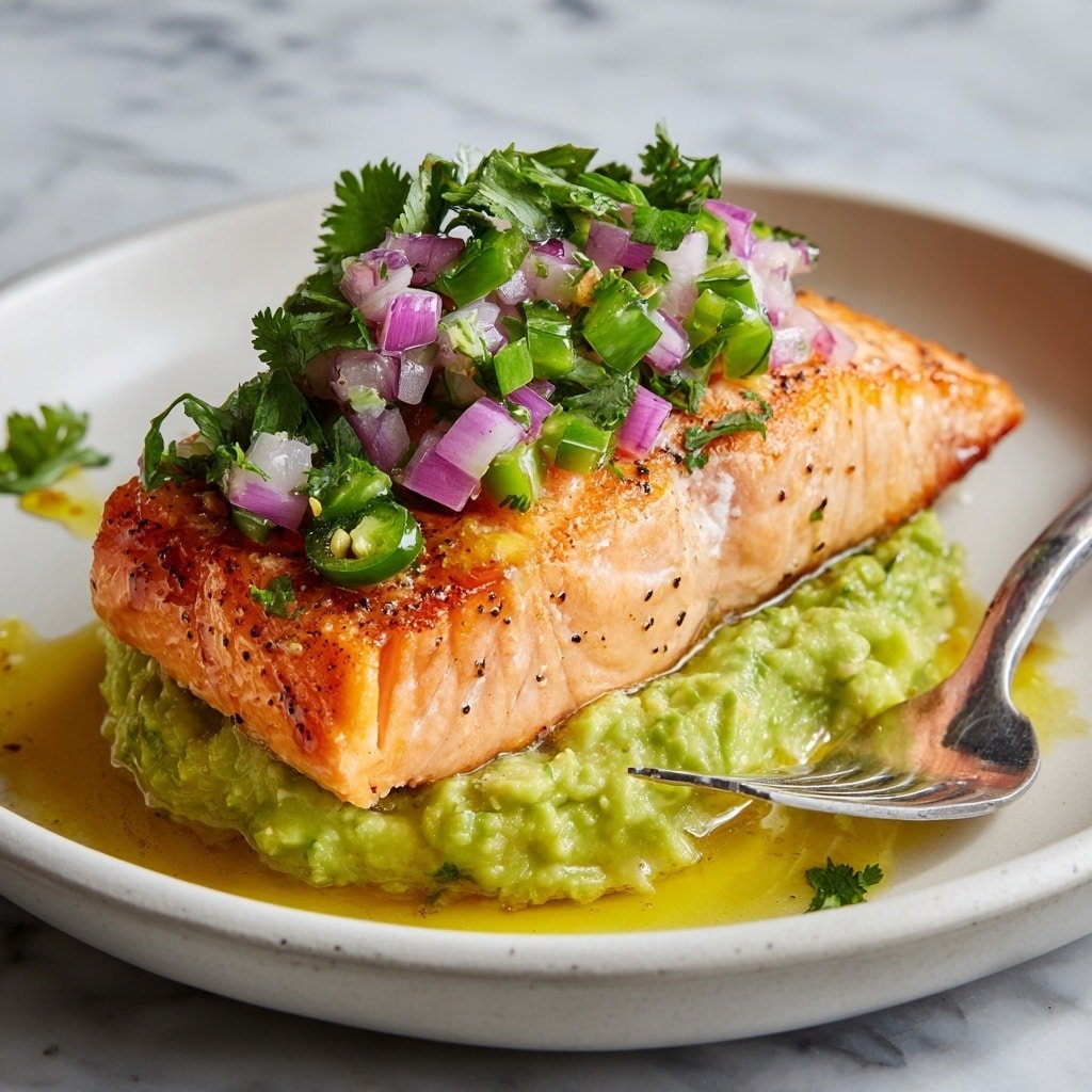 The dish shows two square pieces of cooked salmon with a light orange color and visible white lines, placed side by side on a white plate. On top of each salmon piece, there is a thick layer of chunky green avocado mash. The avocado is garnished with small, uneven pieces of purple-red onion and tiny green herb leaves scattered over it and around the plate. The salmon sits in a light pool of yellow oil that glistens on the plate’s surface. A golden fork is placed on the right side of the plate, partially visible. The background is a white marbled texture. Photo taken with an iphone --ar 1:1 --v 7 — Baked Salmon with Avocado Mash, healthy baked salmon dish, easy salmon recipes, avocado side dish, flavorful salmon dinner