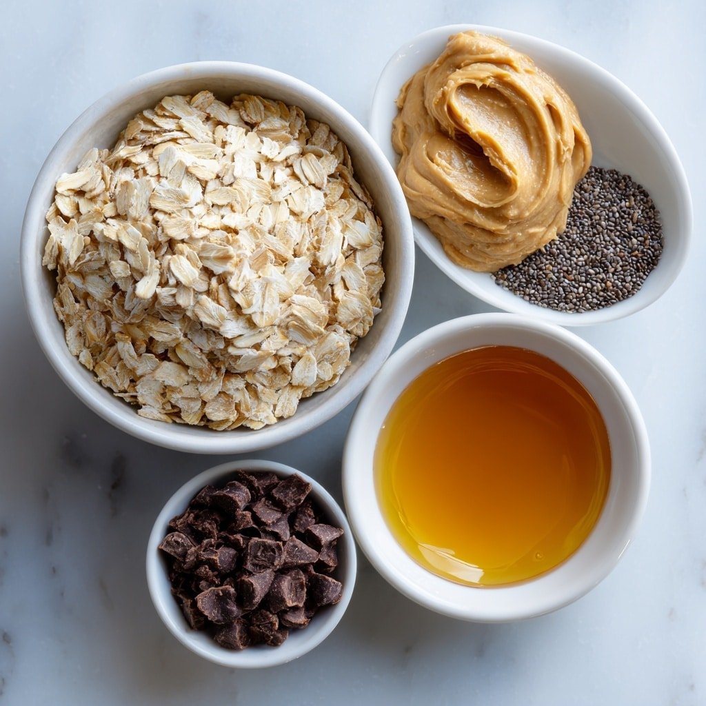 Flat lay of a small white ceramic bowl filled with rolled oats, a dollop of creamy peanut butter beside it on the surface, a small white bowl holding golden maple syrup, a tiny white bowl of black chia seeds, a pinch of coarse salt artfully arranged, and a small pile of mini chocolate chips, all evenly spaced and balanced, placed on a clean white marble surface, soft natural light, photo taken with an iPhone, professional food photography style, fresh ingredients, white ceramic bowls, no bottles, no duplicates, no utensils, no packaging --ar 1:1 --v 7 --p m7354639359234015250 — Healthy Peanut Butter Energy Balls, nutritious snack recipes, easy no-bake energy bites, healthy snack ideas, quick protein balls