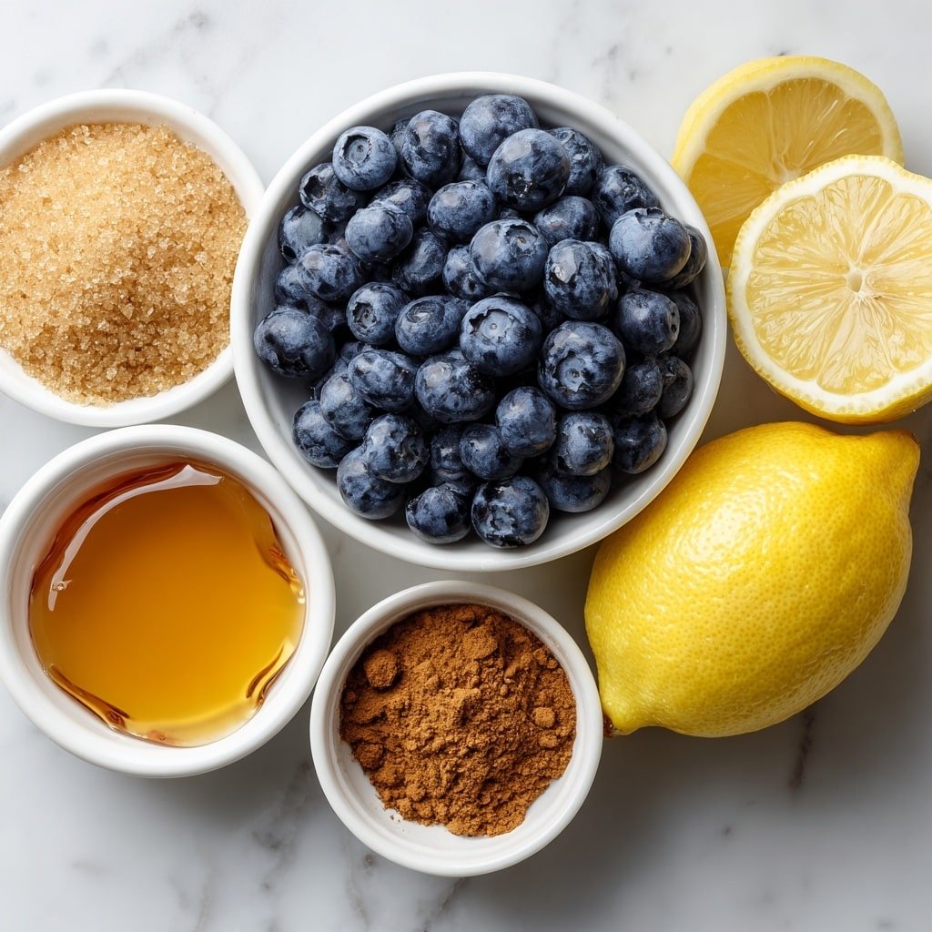 Flat lay of a large cluster of fresh plump blueberries, a small white bowl filled with light brown sugar, a small white bowl containing golden honey, a whole fresh lemon sliced in half with a few lemon slices and visible zest, a small white bowl of ground cinnamon, and a small white bowl of ground nutmeg, all arranged with perfect symmetry and balanced proportions on a clean white marble surface, soft natural light, photo taken with an iPhone, professional food photography style, fresh ingredients, white ceramic bowls, no bottles, no duplicates, no utensils, no packaging --ar 1:1 --v 7 --p m7354639359234015250 — Blueberry Butter in Slow Cooker, homemade blueberry fruit butter, slow cooker berry spread, easy blueberry butter recipe, cozy blueberry breakfast spread